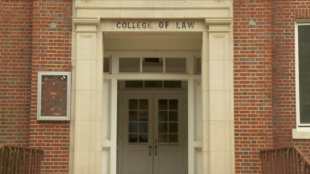 A close up of a brick building with College of Law etched above it.