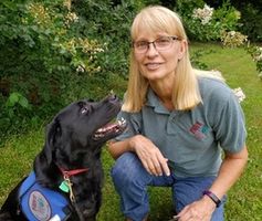 A person holding a dog