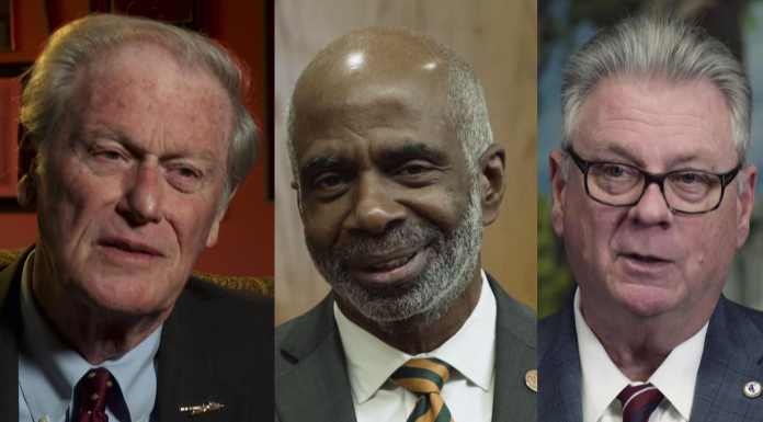 Local College Presidents talk Post – Secondary Attainment John E. Thrasher wearing a suit and tie