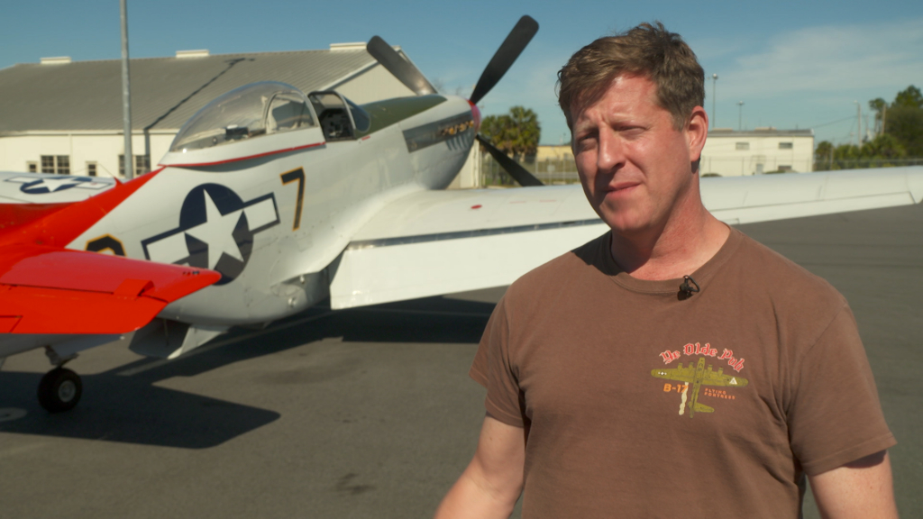 R.H. Thomson standing in front of a plane