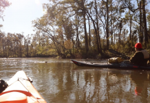 Chipola River Paddling Trail A man sitting in a boat on a body of water