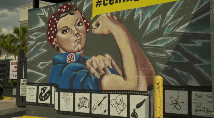 Local Routes: Making History (Episode 507) A person holding a sign