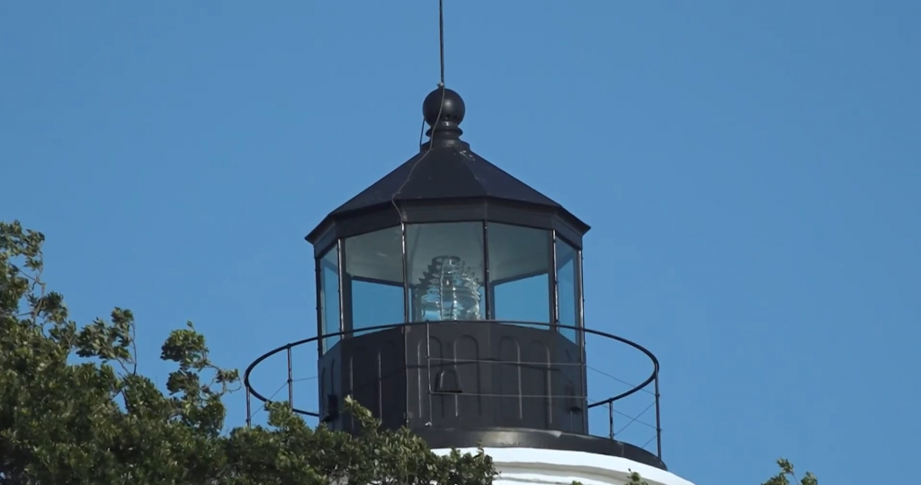 A Fresnel lens is seen in the lamp room of a lighthouse.