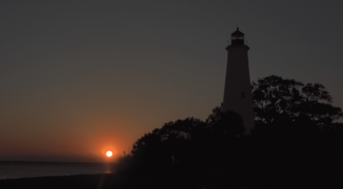 The St. Marks Lighthouse Relighting Hope A clock tower lit up at night