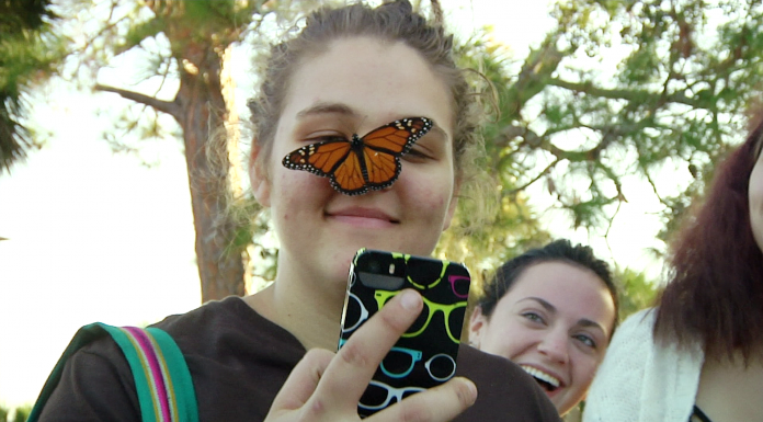 Local Routes: Five Years of Favorites (Episode 510) A person holding a phone and looking at the camera