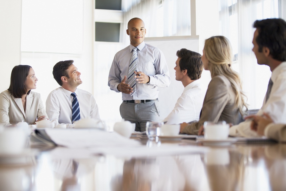 A group of people standing around a table