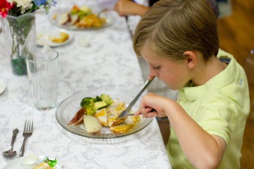 A person sitting at a table eating food