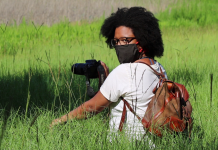 Dara Wilson: Black Birders Week, A Tallahassee Perspective A woman in a green field with binoculars