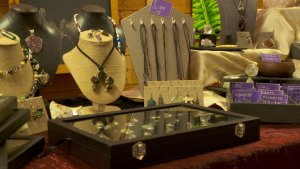 necklaces and other jewelry displayed on a table and in a box