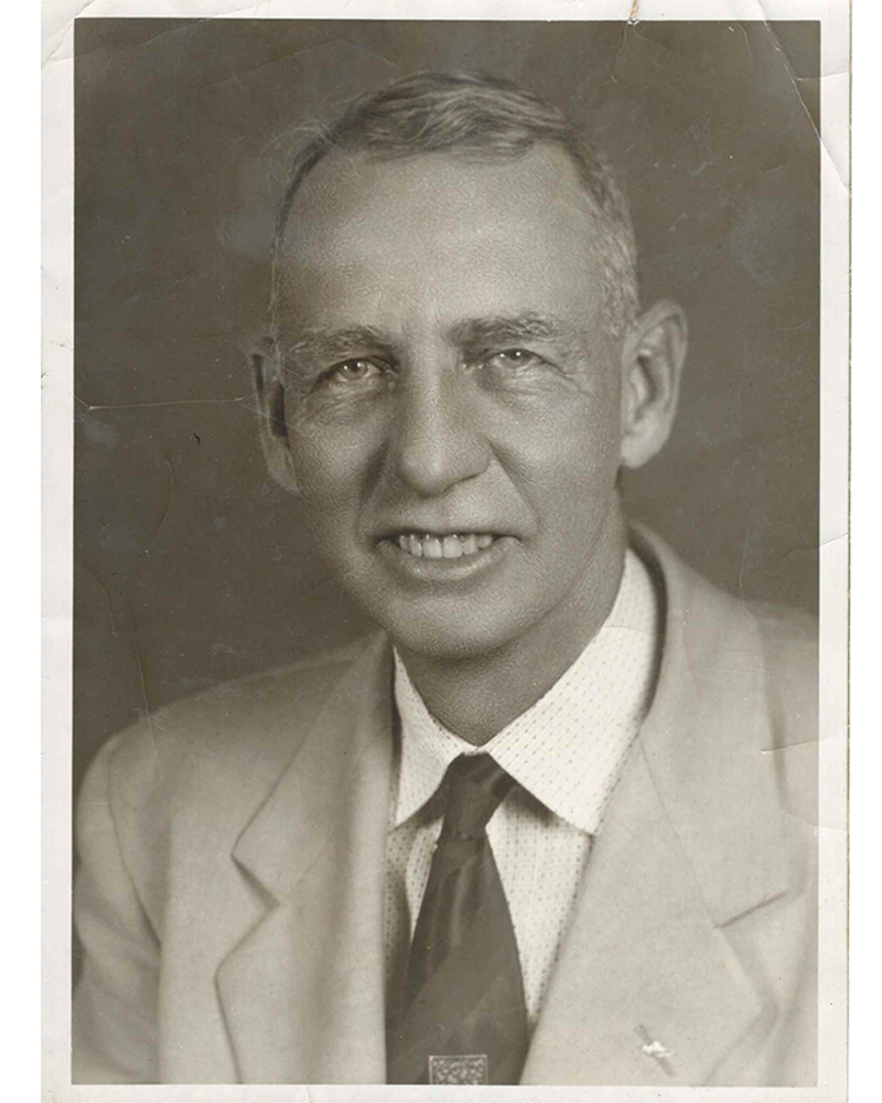 A man wearing a suit and tie posing for a photo.