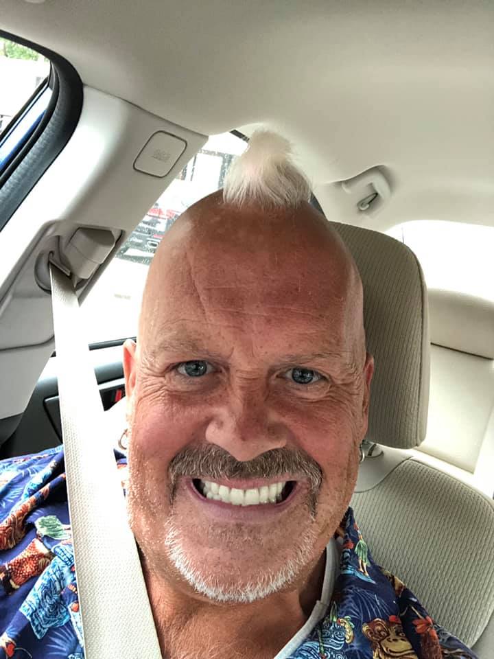 A man sitting on the seat of a car