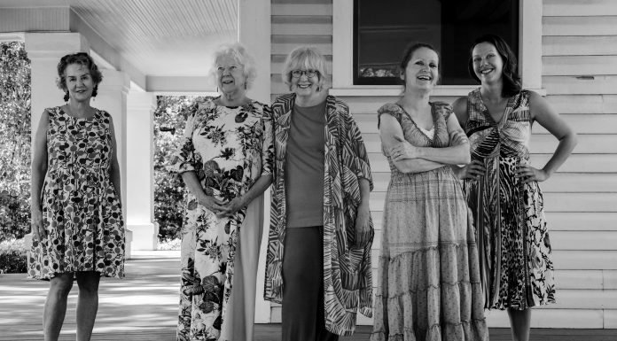 The Women Behind “Women Among Us” A group of people posing for the camera