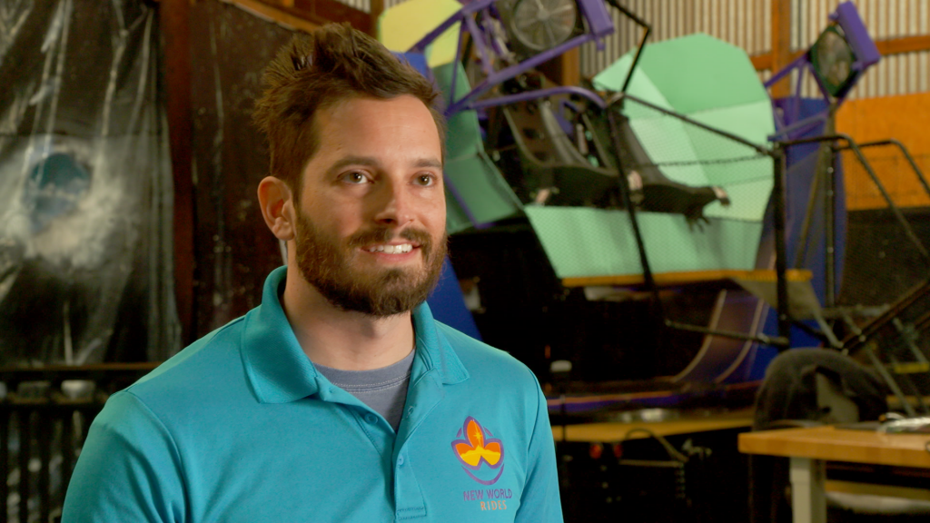 A smiling man in a blue shirt.