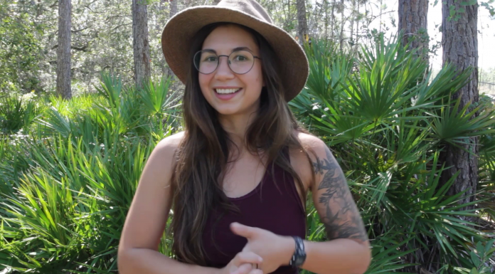 New Ecology Blogger a Researcher, Artist, and Communicator A woman standing in front of a tree