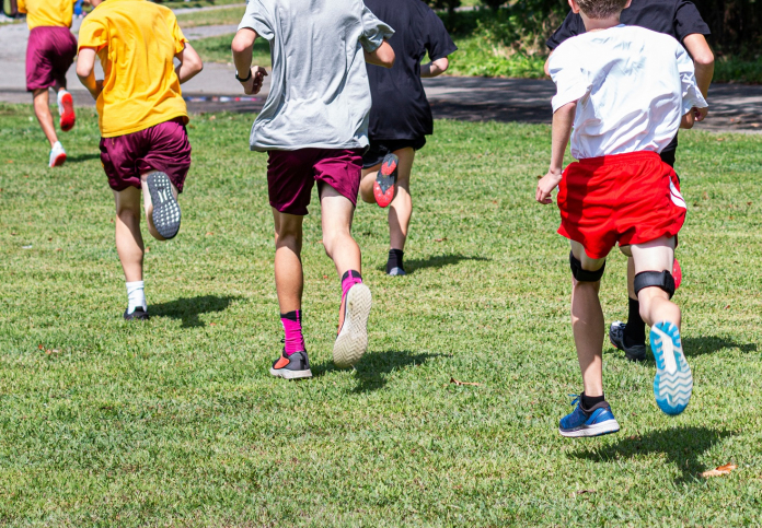 A group of young people playing football on a field