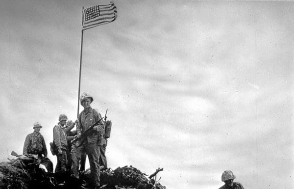 Florida’s Ernest “Boots” Thomas & the Flag at Iwo Jima In World War II A group of people posing for a photo