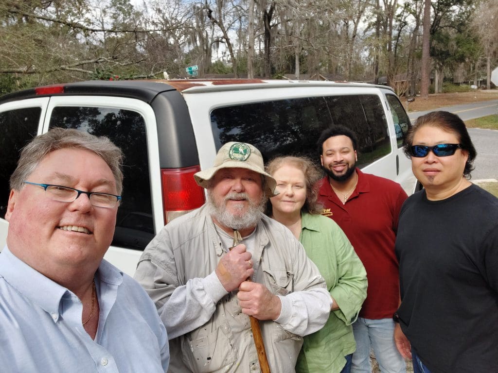 Five people posing for a picture.