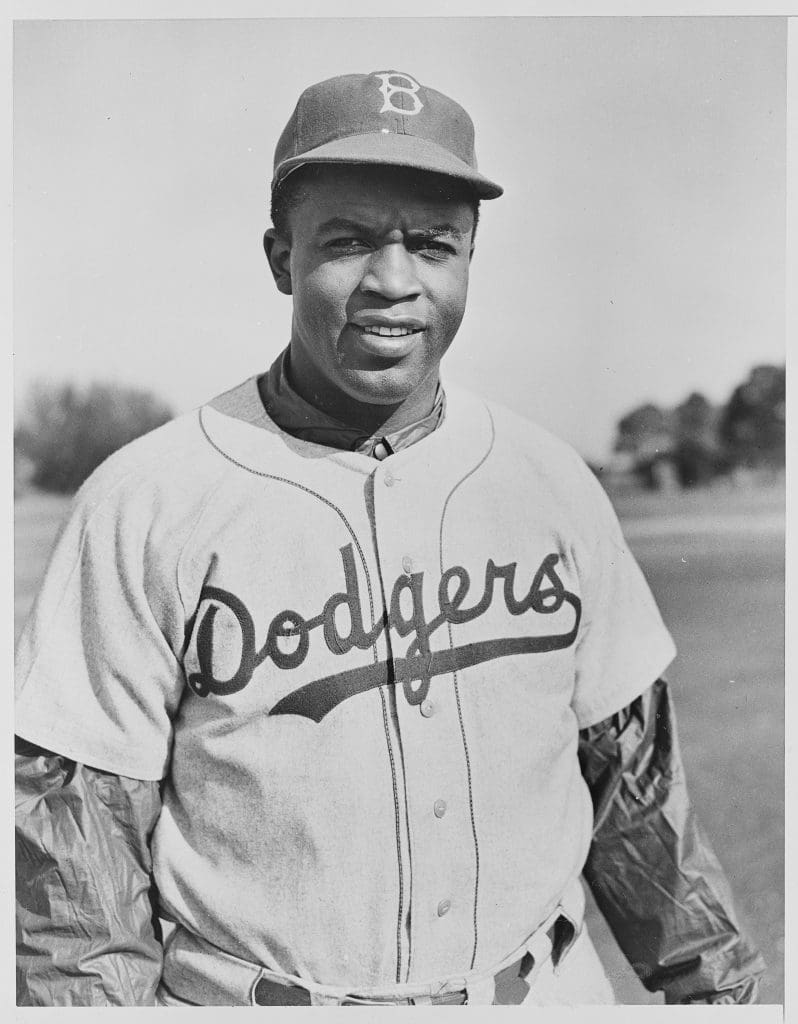 A vintage photo of Jackie Robinson wearing a hat