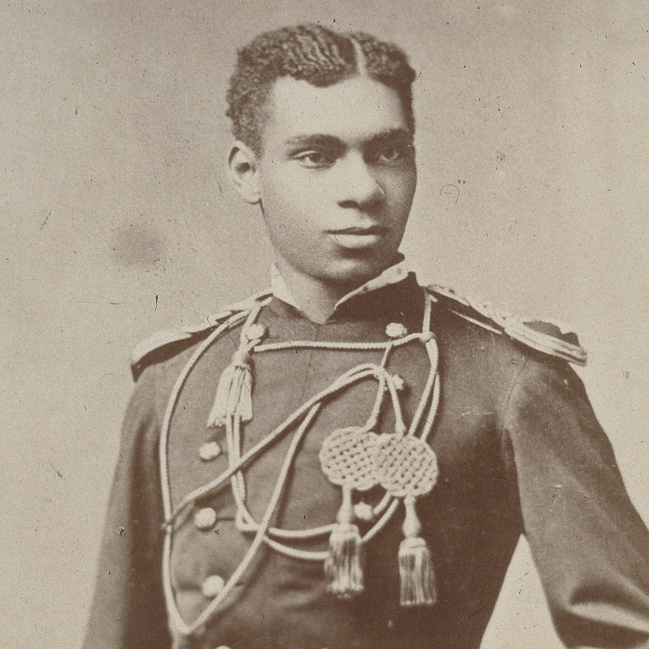 A vintage photo of a young man in a military uniform.
