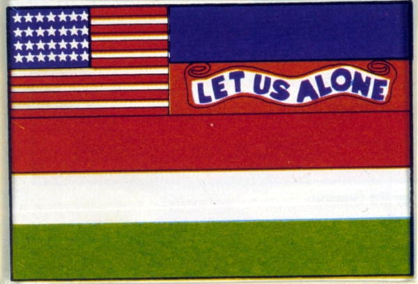 A close up of a flag with red white and green and the words "Let Us Alone"