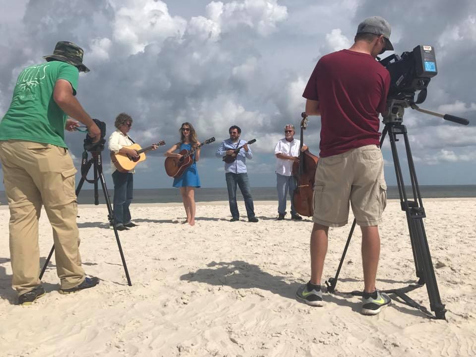 A group of people standing in the sand