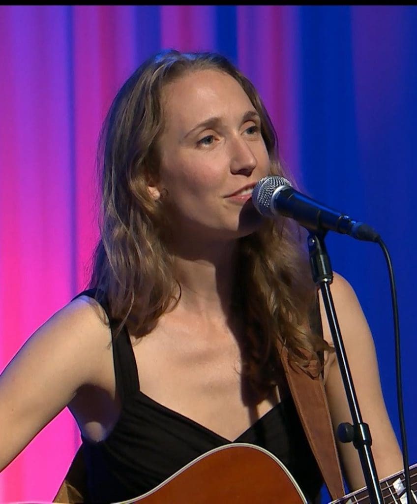 A woman sitting on a stage