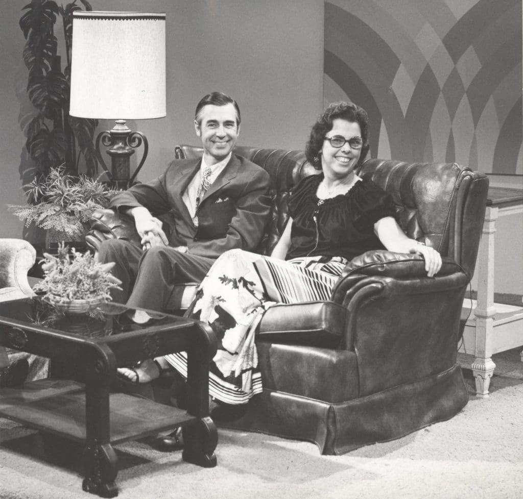 Fred Rogers and his wife are sitting on a couch on a WFSU set