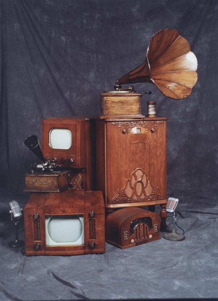 TVs and radios stacked on top of each other.  Victrola and microphones too.