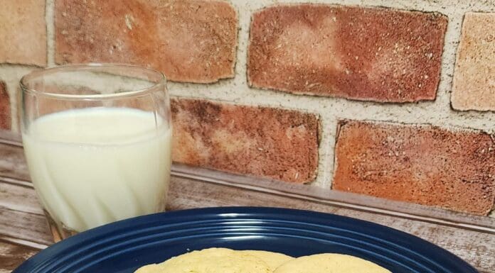 Recipes from Our Local Routes | Mary Archer’s Tea Cakes three cookies on a blue plate next to a glass of milk