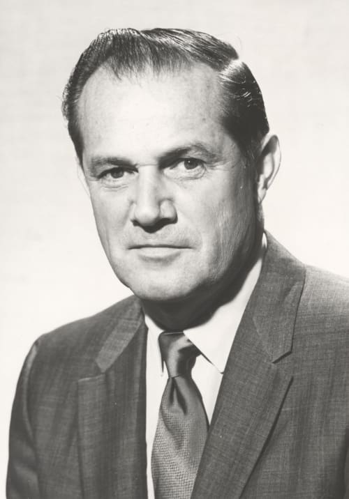 A man wearing a suit and tie looking at the camera