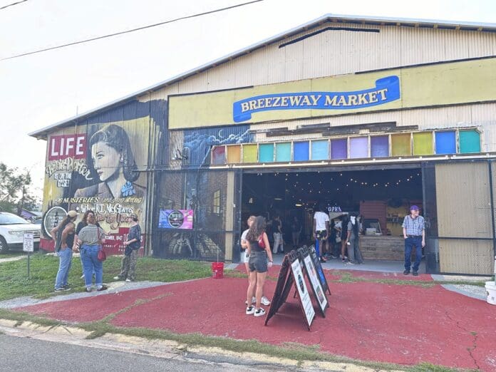 A group of people standing in front of a store