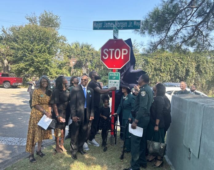 A group of people standing around a stop sign