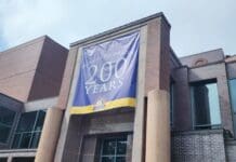 Tallahassee’s Bicentennial (Episode 1005) A large brick building with a sign that says 200 years