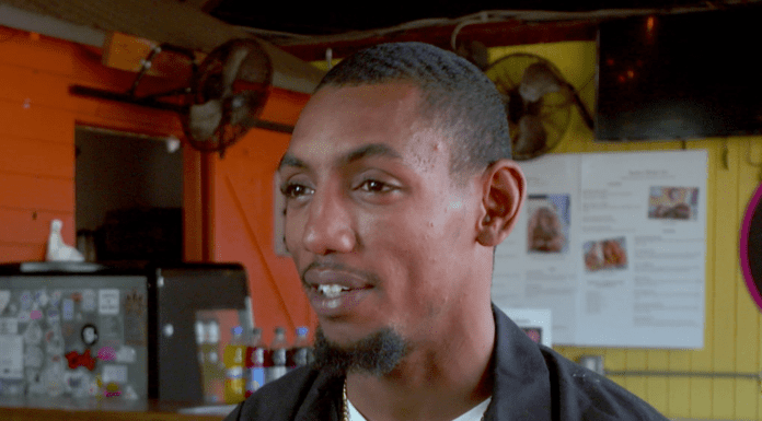 Water Ice in the Panhandle|The Spirit of Rebuilding at Railroad Square A man standing in front of a store