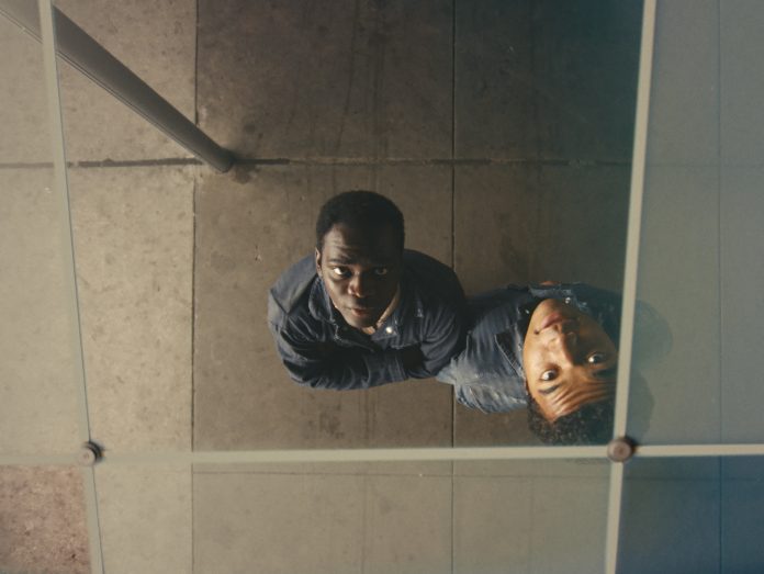 A man and a woman taking a selfie in a mirror