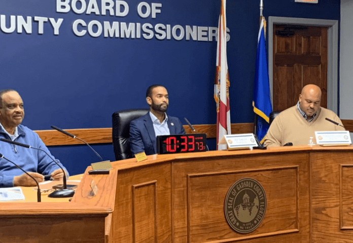 Al Lawson, Craig David, Corey Simon sitting at a desk