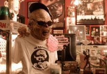 One of the Last Movie Rental Store in Tallahassee Alien stands next to popcorn machine in eclectic store