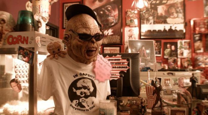 One of the Last Movie Rental Store in Tallahassee Alien stands next to popcorn machine in eclectic store