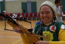 Medieval Combat in Tallahassee Women smiles as she holds her middle aged style weapon and wears clothing inspired from that time