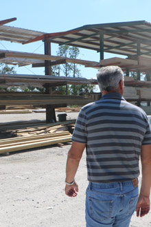 man walking in lumber yard