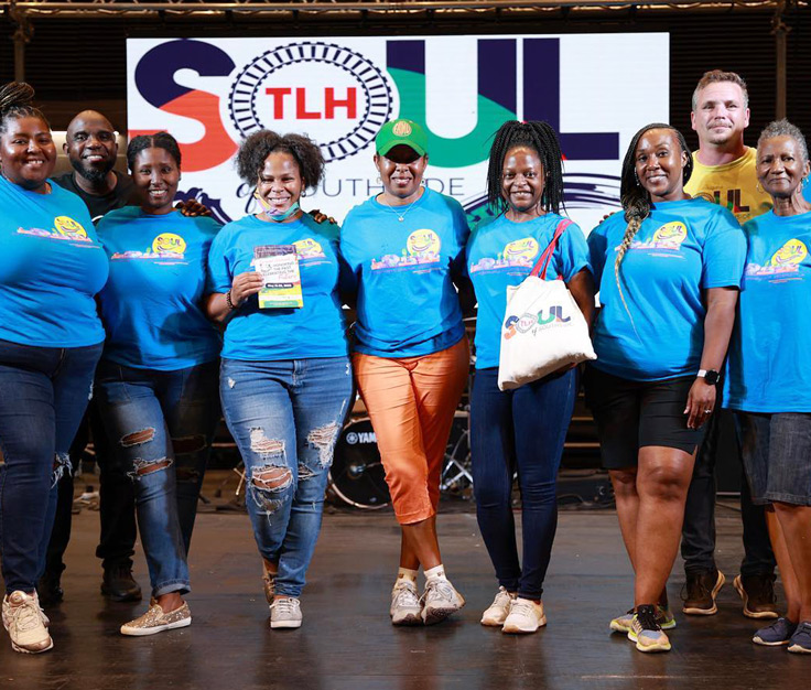 a group poses in front of a south of Southside festival tlh sign