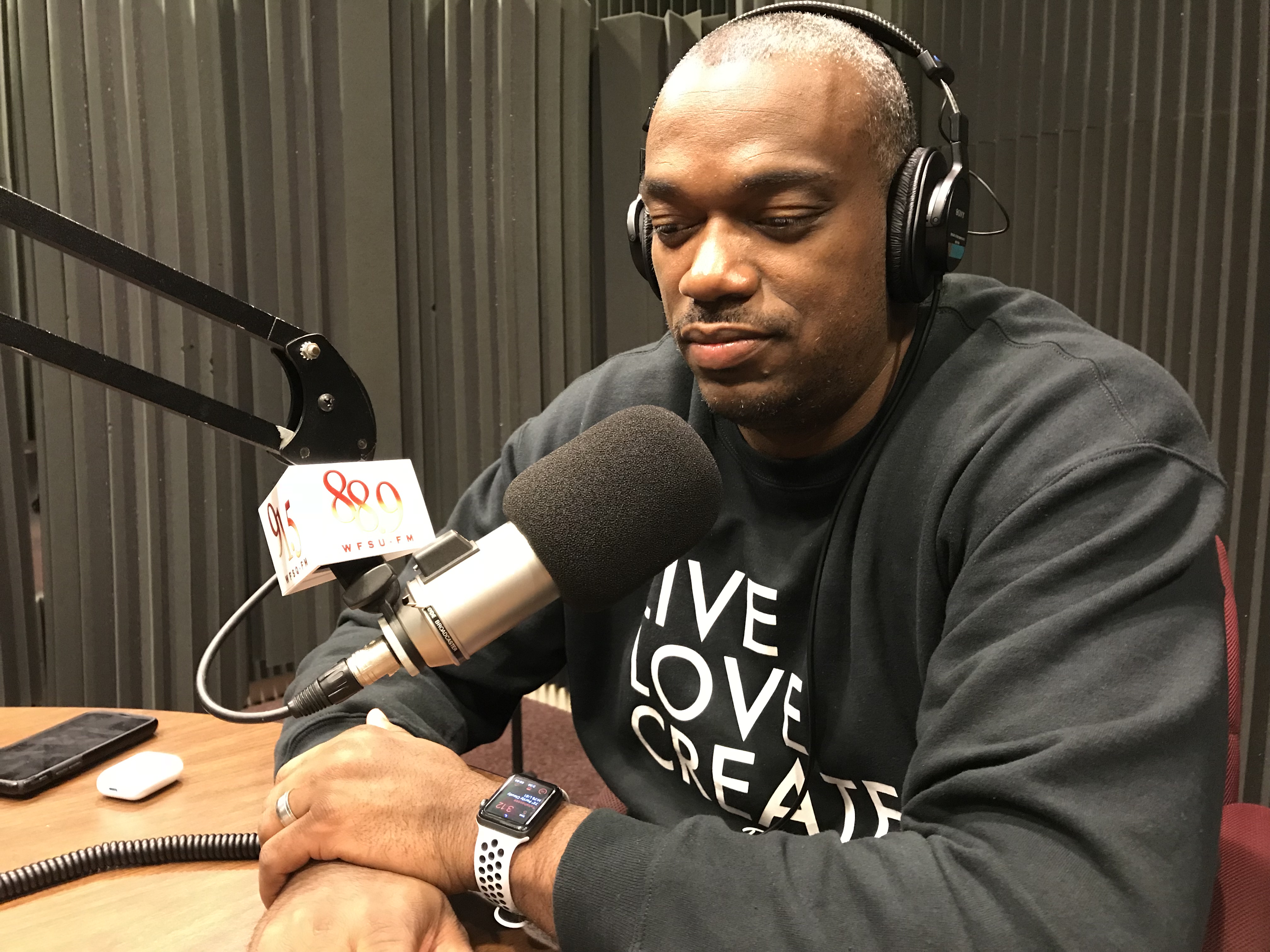 Adrian looking down near the microphone