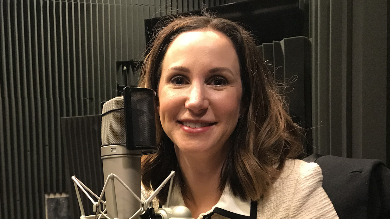 Amy Hecht at WFSU wearing headphones in the radio studio