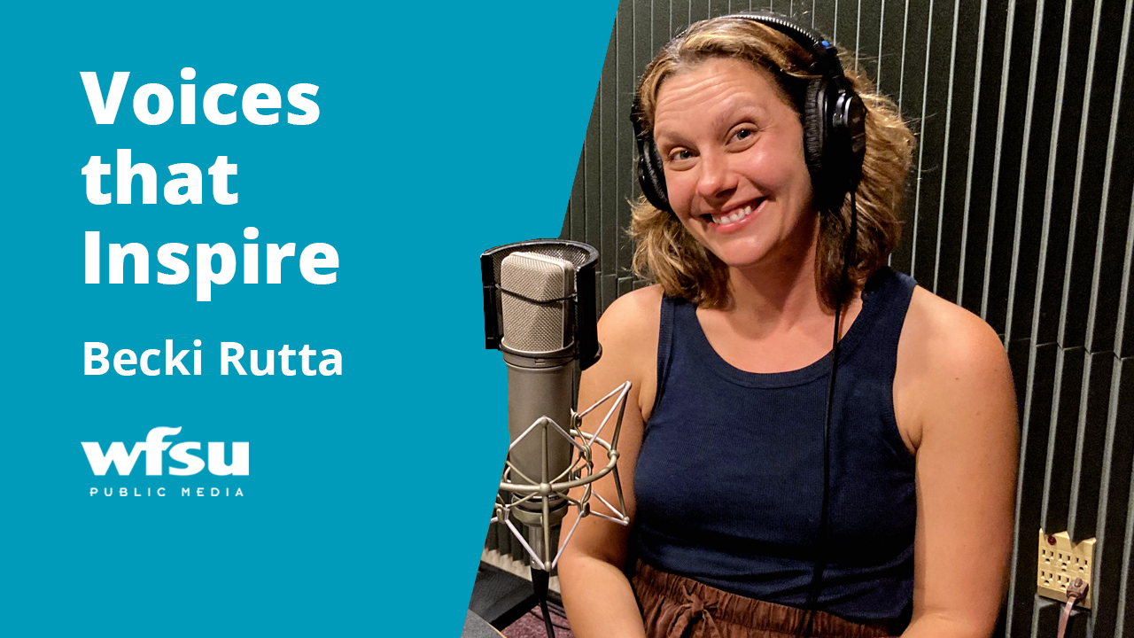 Woman smiling wearing headphones.