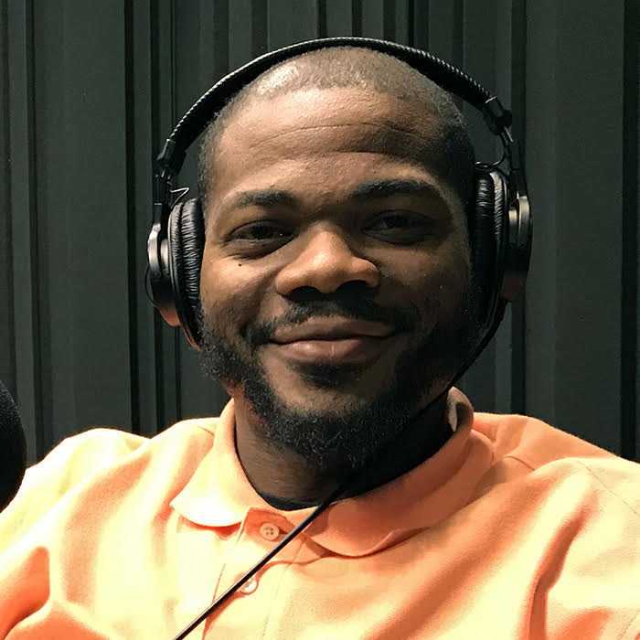 Square headshot of Calvin Hall Jr wearing headphones