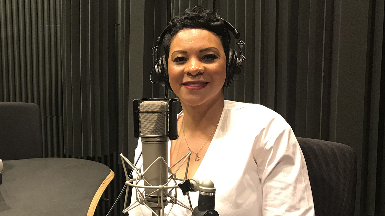 Carmen Conner with headphones on in front of a microphone