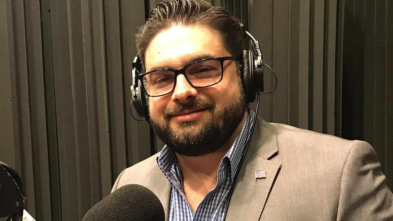 Eddie sitting in a suit