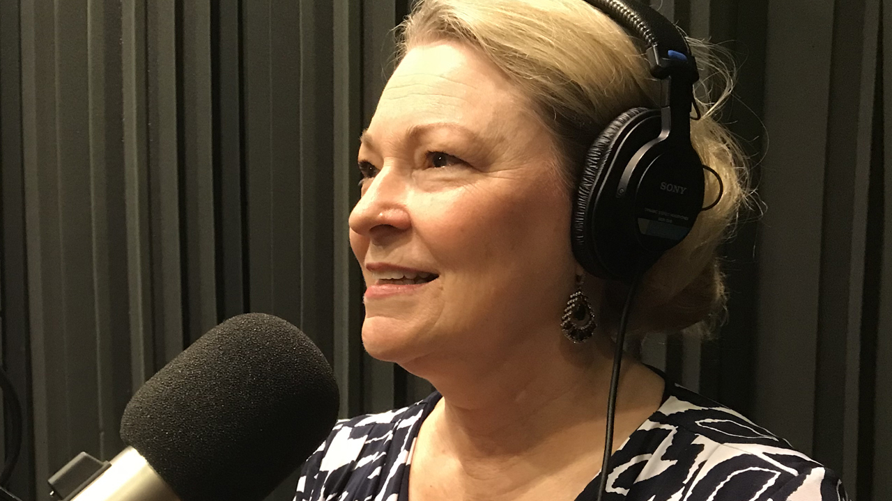 Karen Moore in front of the microphone