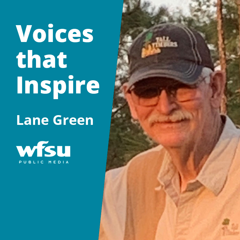 Smiling man in baseball cap.