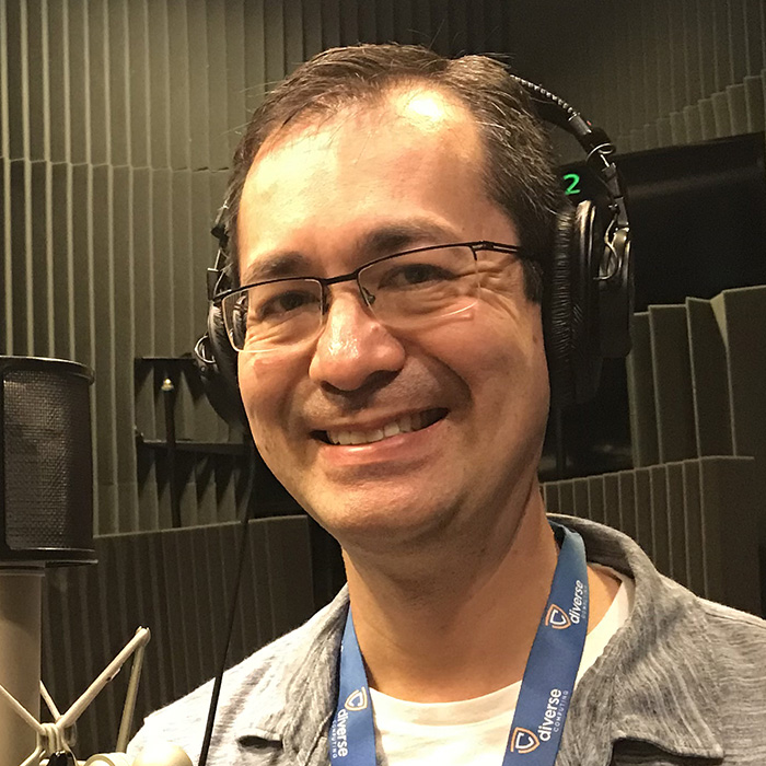 Lester Hutt smiling and wearing headphones